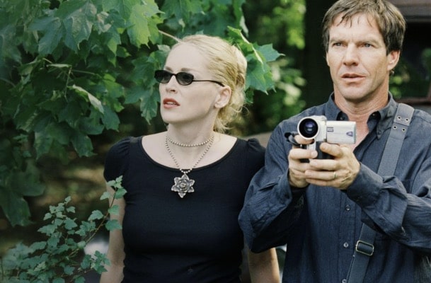 The image of Dennis Quaid (far right) on the screen in 2003, with actress Sharon Stone on the far left